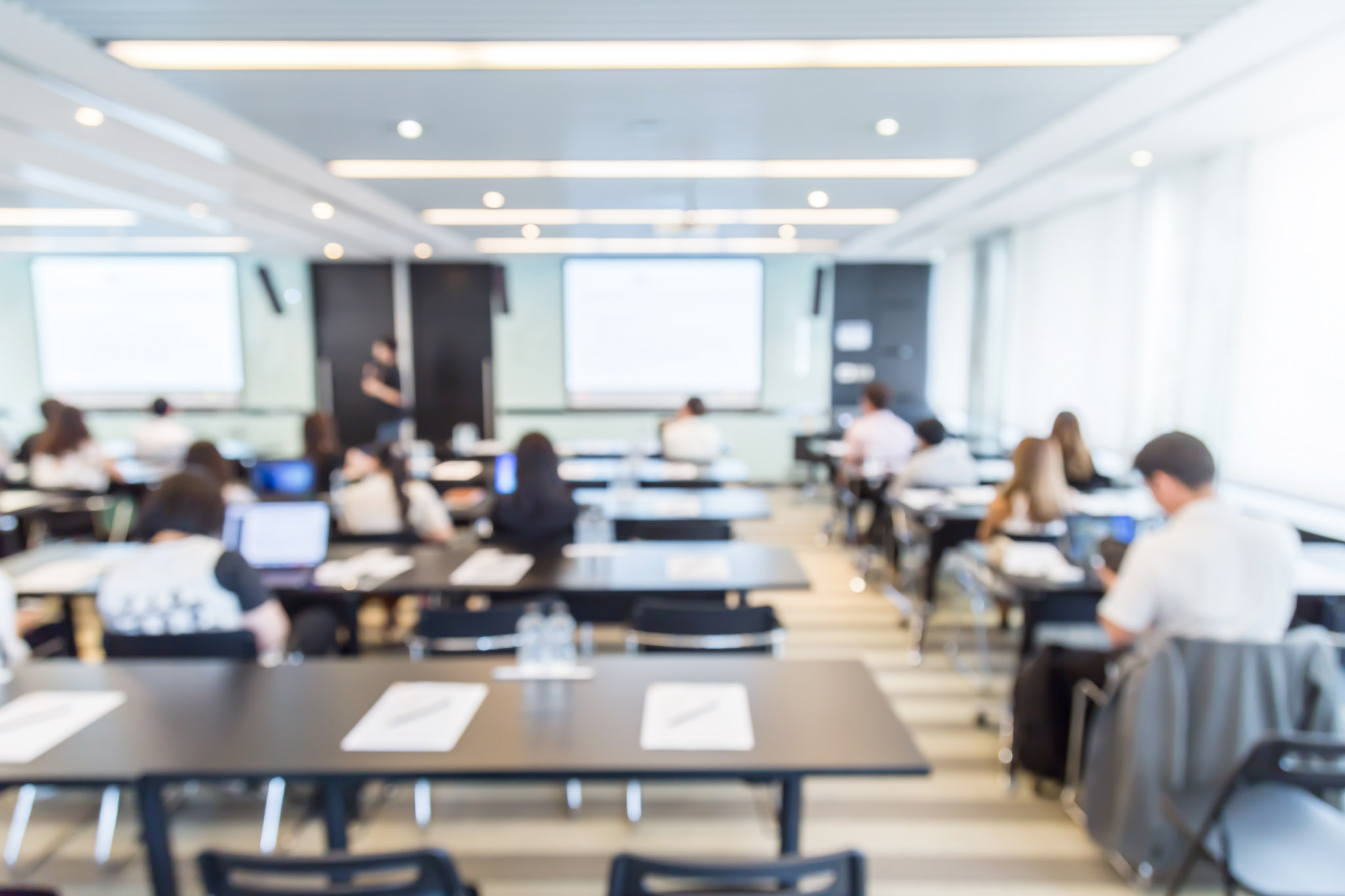 A blurry view of a college class in session